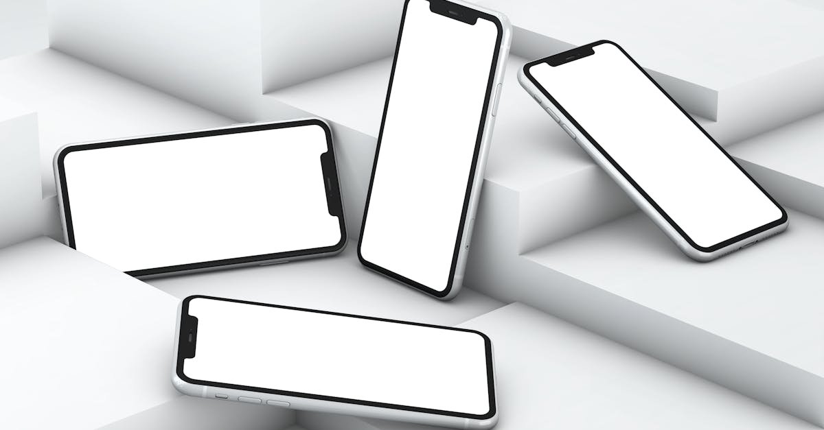 Four smartphones with white screens arranged on geometric white steps in a minimalist setting.