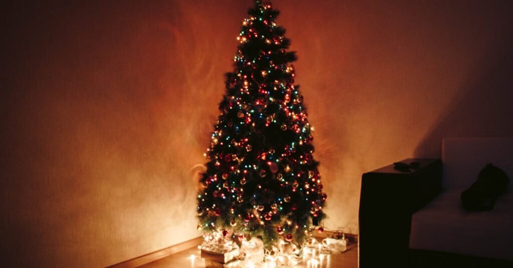 Elegant Christmas tree with vibrant decorations and glowing lights in a cozy indoor setting.