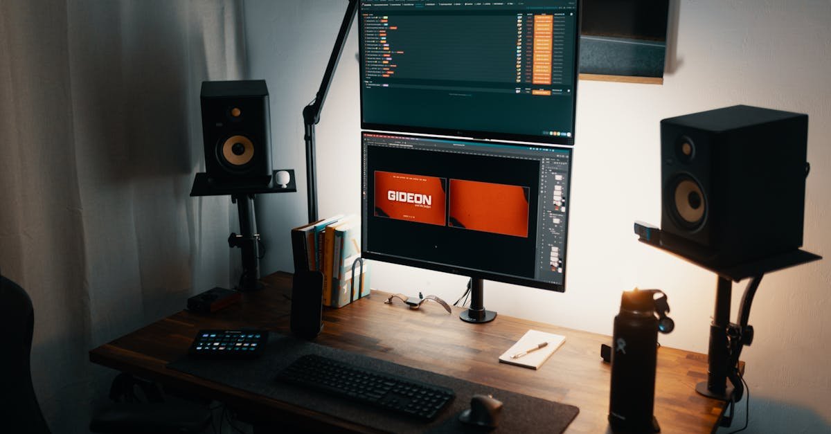 A well-lit modern workspace featuring dual monitors, speakers, and a tidy desk setup.