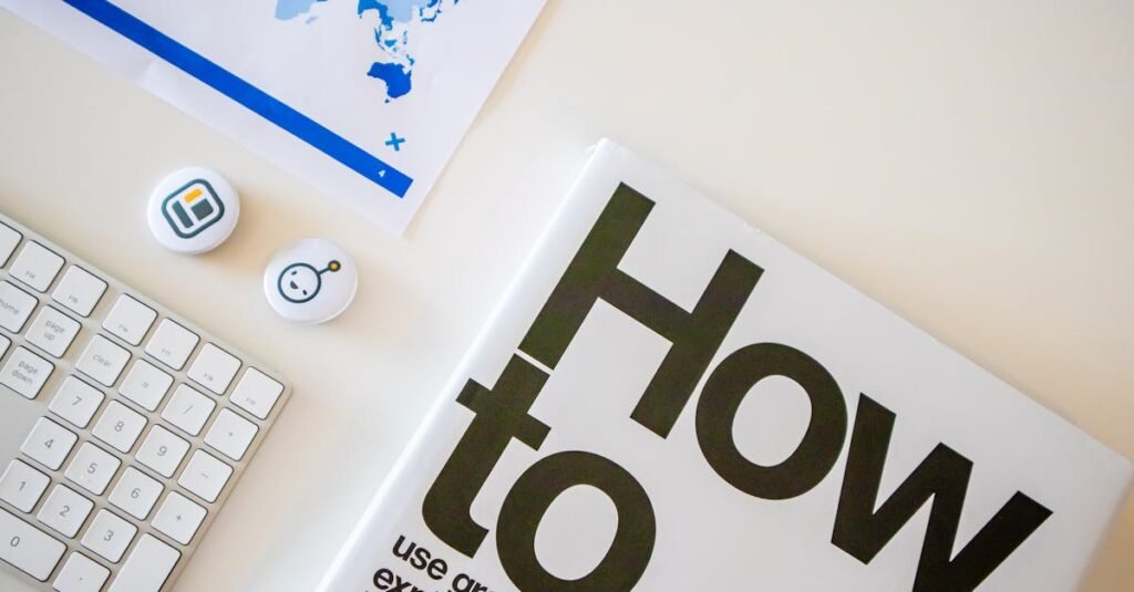 Stylish desk setup with a how-to book, keyboard, and world map on paper.